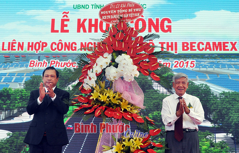 Chủ tịch UBND tỉnh Nguyễn Văn Trăm nhận lẵng hoa chúc mừng của nguyên Tổng bí thư Lê Khả Phiêu tặng Đảng bộ, chính quyền và nhân dân tỉnh Bình Phước
